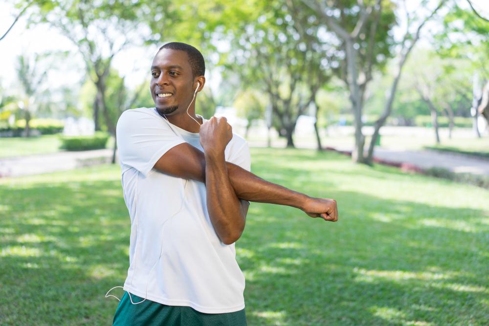 Man doing physical therapy stretch outdoors